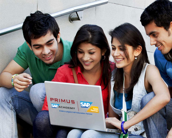 A group of college students sitting on steps, engrossed in learning SAP ABAP on a laptop for certification.